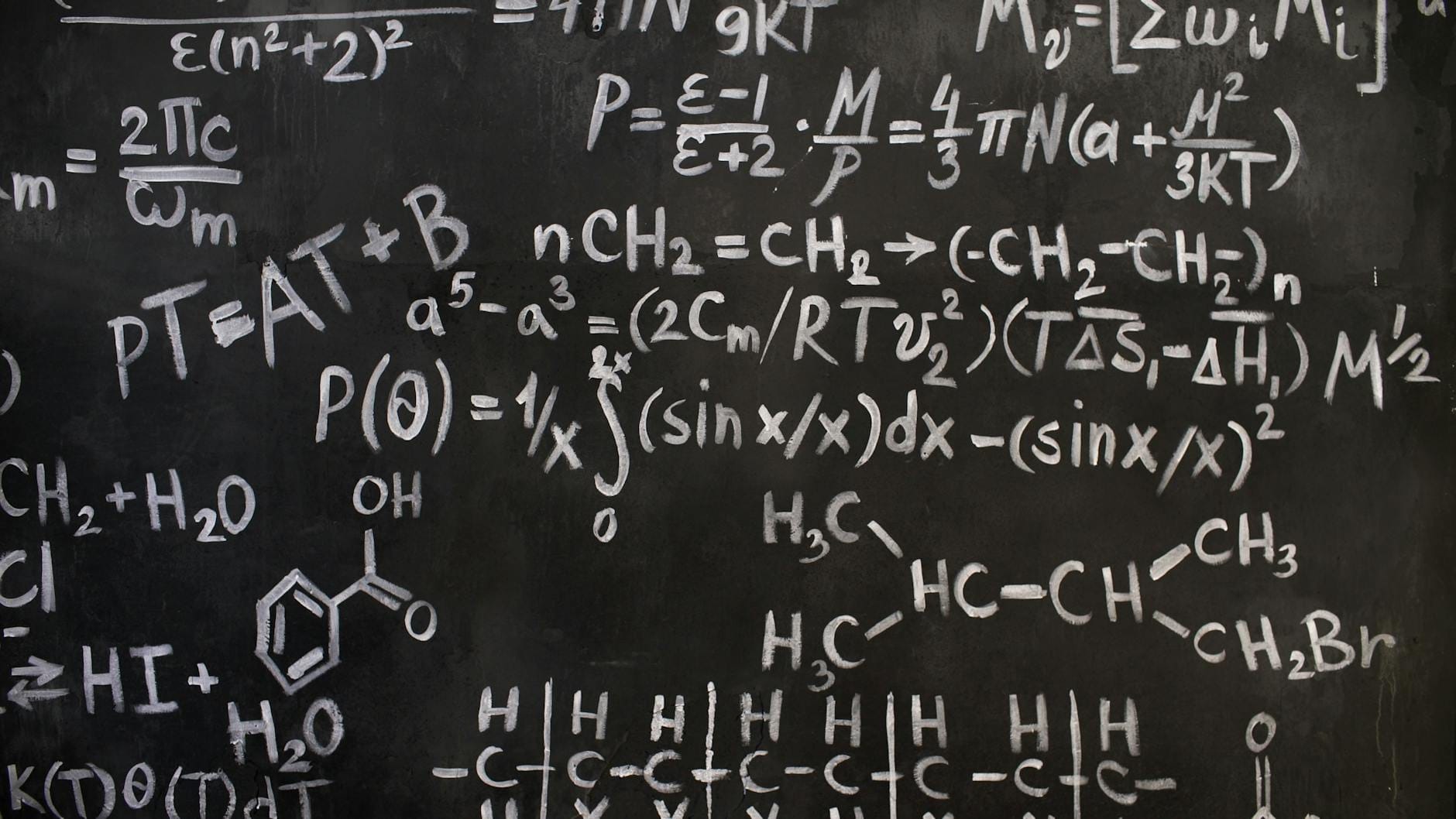 close up of complicated equations written on a blackboard